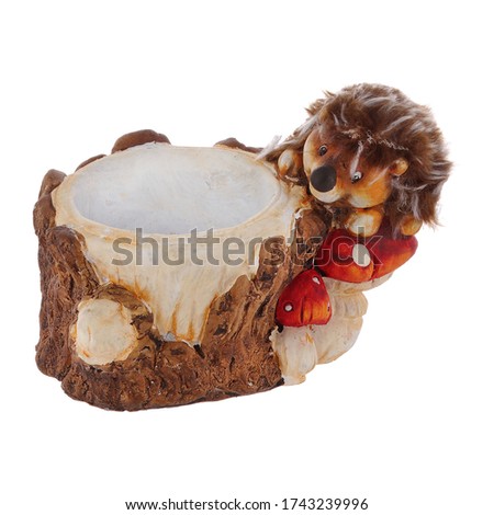Isolated close up view of souvenir decorative pot in the shape of bucket and hedgehog on white background.                