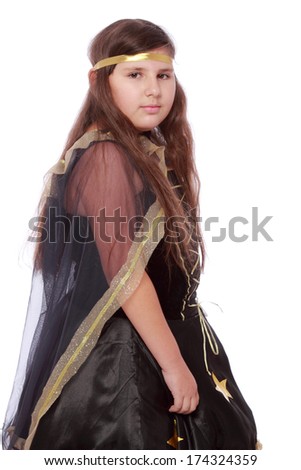 Cute little girl with a sad smile in fancy black dress on Halloween