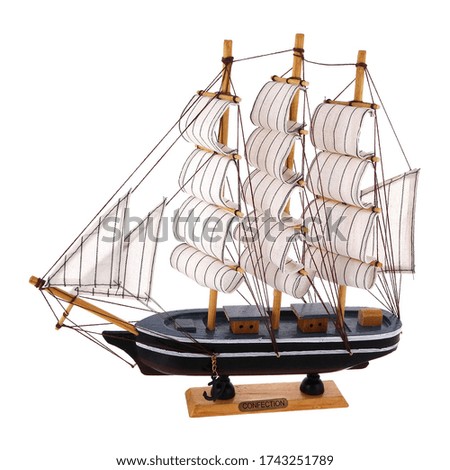 Isolated close up view of souvenir scale model of an old sailing ship on white background.