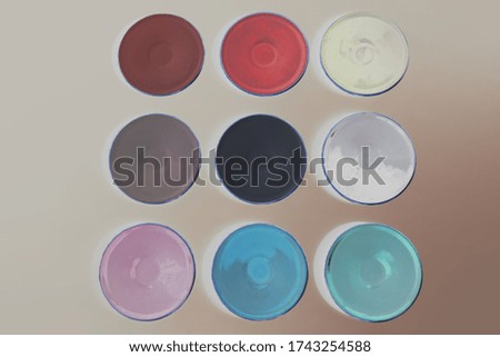 
set of small plates, colored, beige background