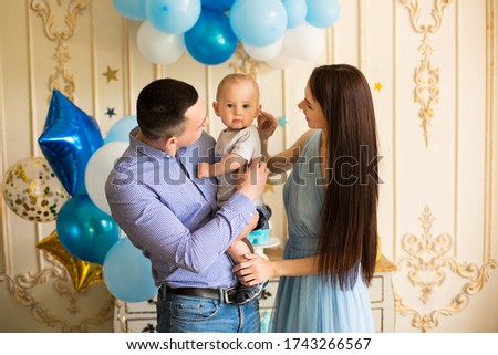Happy family with baby boy at party