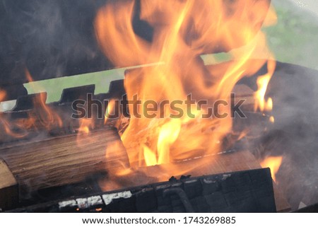 Firewood is burning in the barbecue grill. Flaming Charcoal Grill With Close up.