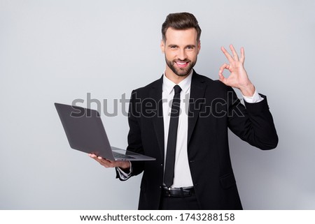 Portrait of confident smart entrepreneur man hold computer work project approve show okay sign wear formalwear outfit isolated over grey color background