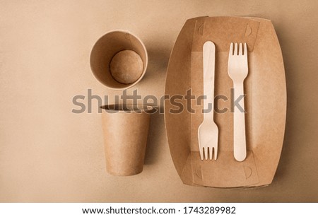 Eco friendly fast food containers on paper bag background.