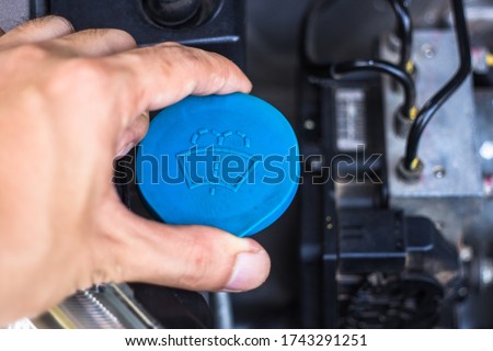 car windshield wiper cleaning spray water reservoir black bottle cap with clear and communicative pictogram sign symbol show the liquid function inside
 Royalty-Free Stock Photo #1743291251