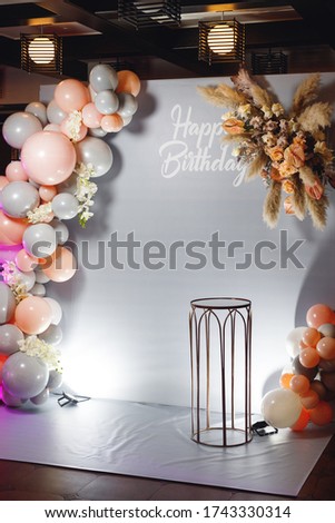Birthday photozone with pampass grass, color ballons and glass table. Photozone for children's holiday. Photozone with text Happy Birthday Royalty-Free Stock Photo #1743330314
