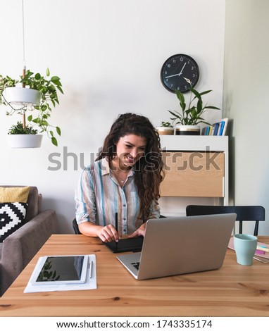 Graphic designer woman hands on retouching pad and laptop computer stock photo