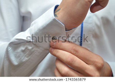 Men wear a shirt and cufflinks.