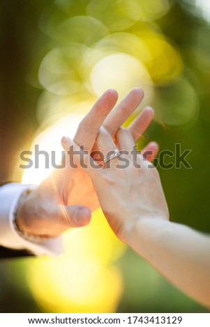 Couple. You can see the hands touching each other. Sensually.Focus on the wedding ring Royalty-Free Stock Photo #1743413129