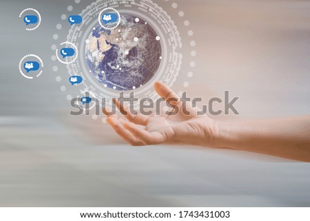 Businessman holding in hand with global connection concept and social media icons.Elements of this image furnished by NASA
