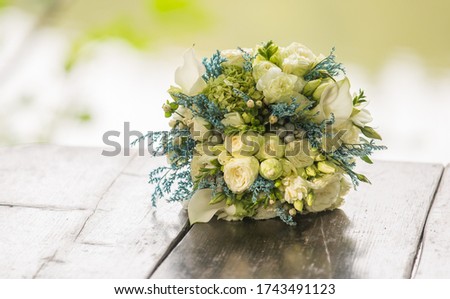 peonies roses tulips bouquet of flowers on a leg in the interior 