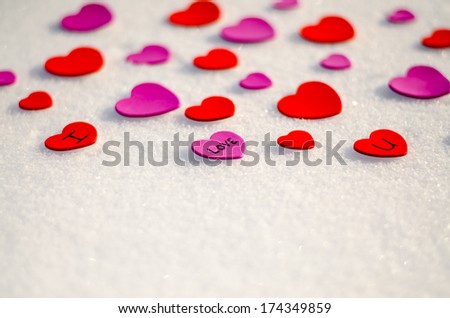 Colorful paper & felt heart Valentines background in the snow