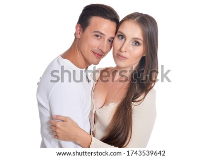 Portrait of happy beautiful young couple posing on white background
