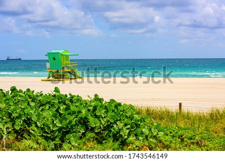 Sunny day in Miami beach. Miami Beach with lifeguard tower and coastline with colorful cloud and blue sky
