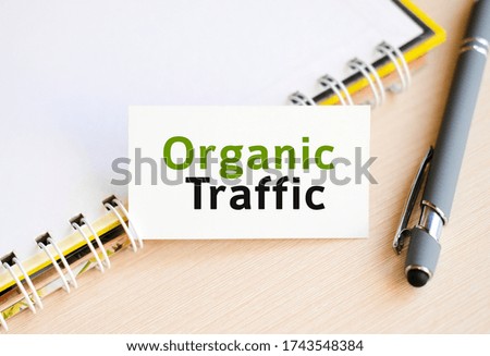 Organic seo traffic - text on a notebook with a spring and a gray handle