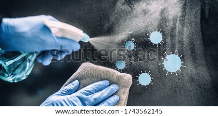 Cleaning home table disinfecting spray spraying on surface to sanitize COVID-19 prevention sanitizing for aerosol droplets. Coronavirus sanitize protection. Panoramic banner. Royalty-Free Stock Photo #1743562145