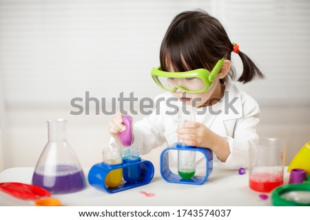 toddler girl pretend play scientist role for homeschooling  Royalty-Free Stock Photo #1743574037
