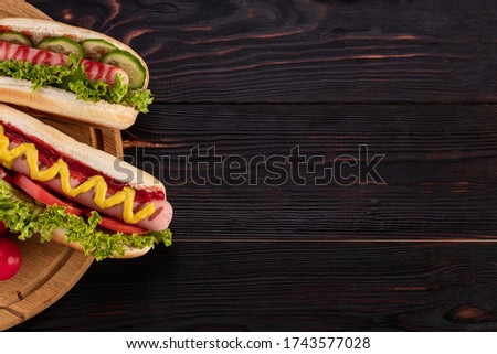 Hot dogs on wooden background. Top view with copy space. Fast food concept.