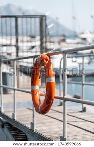 Orange rescue circle at the Yacht Club Rescue buoy