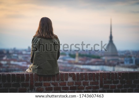 brunette woman enjoy panorama of Turin. Amazing scenic view on Mole Antonelliana. Girl explore Piemonte, Italy. Town and mountain. Cityscape, old historic architecture. Travel, adventure, lifestyle