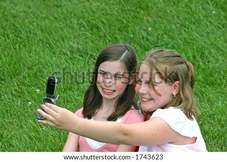 Two Girls Taking Picture with Cell Phone