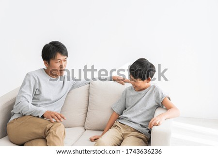 Asian father and son relaxing