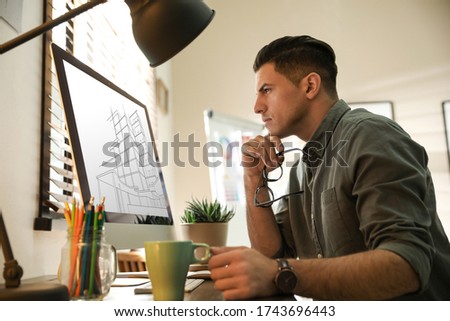 Architect making project of house on computer in office