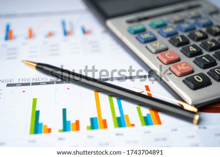 Calculator on chart and graph spreadsheet paper. Finance development, Banking Account, Statistics, Investment Analytic research data economy, Stock exchange trading, Business company concept. Royalty-Free Stock Photo #1743704891