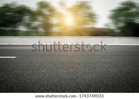 Highway with frontal blurry asphalt road Royalty-Free Stock Photo #1743749033