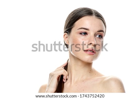 A close-up portrait of a girl with freckles and clear skin. Light blue eyes. The girl has different emotions, she looks at the camera. Isolated on a white background and there is a place where you can
