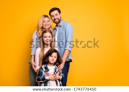 Photo wife mother lady handsome husband dad couple hug adopted little school girl daughter small son boy happy together wear casual shirts clothes isolated yellow color background Royalty-Free Stock Photo #1743776450