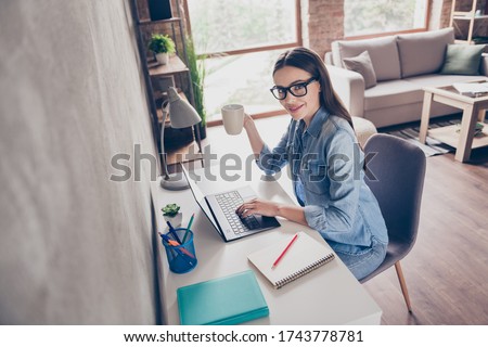 Profile photo of beautiful busy student serious lady chatting notebook typing boss report drink coffee break pause quarantine stay home sit chair desktop flat apartments room indoors