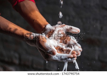 Washing hands.Man washing his hands in the garden at home. Corona virus pandemic prevention wash hands with soap warm water and rubbing nails and fingers washing frequently. Hygiene & Cleaning Hands.