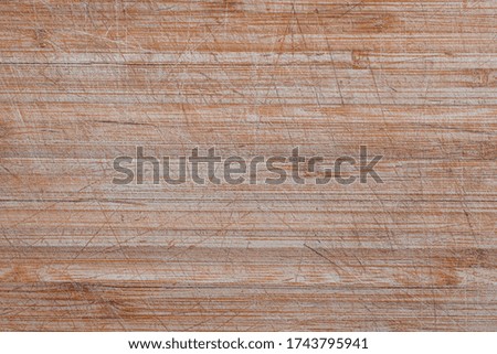 Texture of Old and used natural wooden cooking board with cuts background. Background of old wooden cutting board