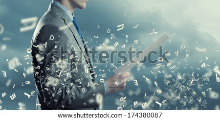 Back view of businessman reading documents in hand Royalty-Free Stock Photo #174380087