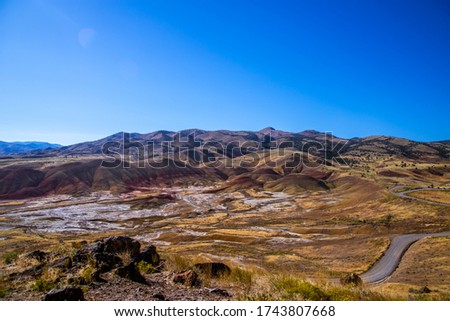 Top view of a salt-covered valley and colored hills. Painted Hills, John Day Fossil Beds National Monument, Oregon, USA. 