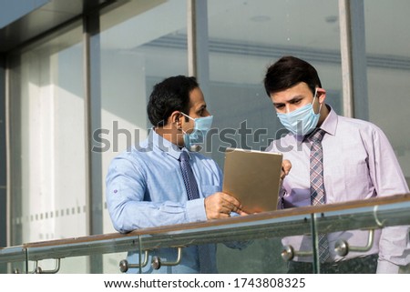 Office worker meeting with face mask quarantine from coronavirus or COVID-19
