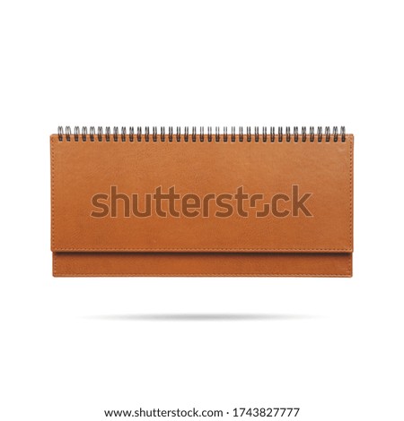 Closed spiral notebook in leather bindingon a white background. Place for text.
