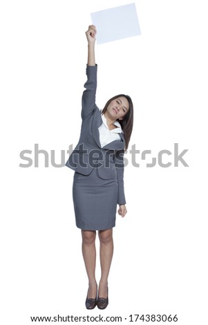Full length happy smiling young pretty attractive brunette Asian business woman standing positive showing blank signboard, isolated on white background