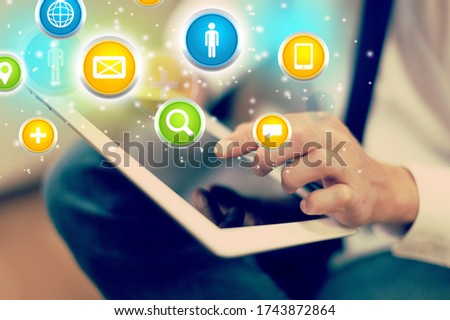 Business icons with hand holding a digital tablet