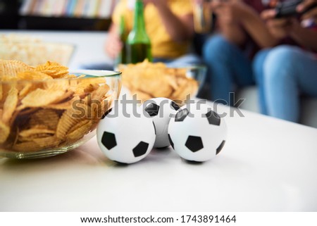 Detail of balls and potato chips on the table