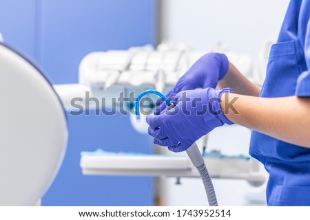 European medical health care system. Public clinic, macro shot of a dental assistant helping with saliva ejector and sucker during dentist treatment. Commercial use, copy space. Royalty-Free Stock Photo #1743952514
