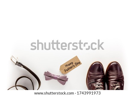 Happy Father's Day . Pink Bow Tie, glasses, purse  and Shoes on white background top view 