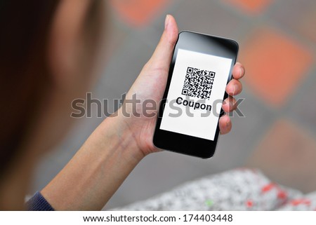 Coupon QR code on smart phone  Royalty-Free Stock Photo #174403448