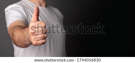 Man's hand showing thumb up - like sign, positive concept. High resolution product. Banner with blank space for text.