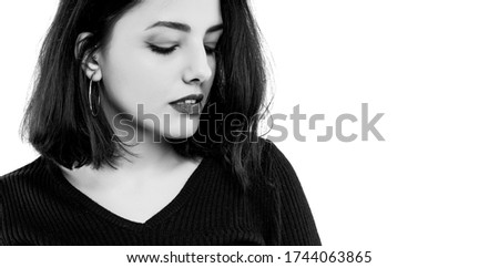 Black and white  young woman is looking down. Portrait of beautiful woman isolated on white background.