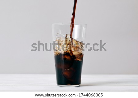 Pouring iced coffee into a glass