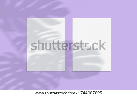 Blank white vertical paper sheet 5x7 on liliac background with shadow overlay. Modern and stylish greeting card or wedding invitation mock up