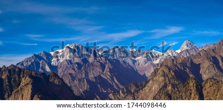 Mesmerizing view of Kamet, Parvati and Neelkanth mountains of Garhwal Himalayas from Kuari pass hiking trail near Auli,Uttrakhand,India. Royalty-Free Stock Photo #1744098446
