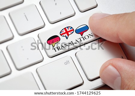 Foreign language translation concept, online translator.Male hand pressing the computer button to translate foreign languages.